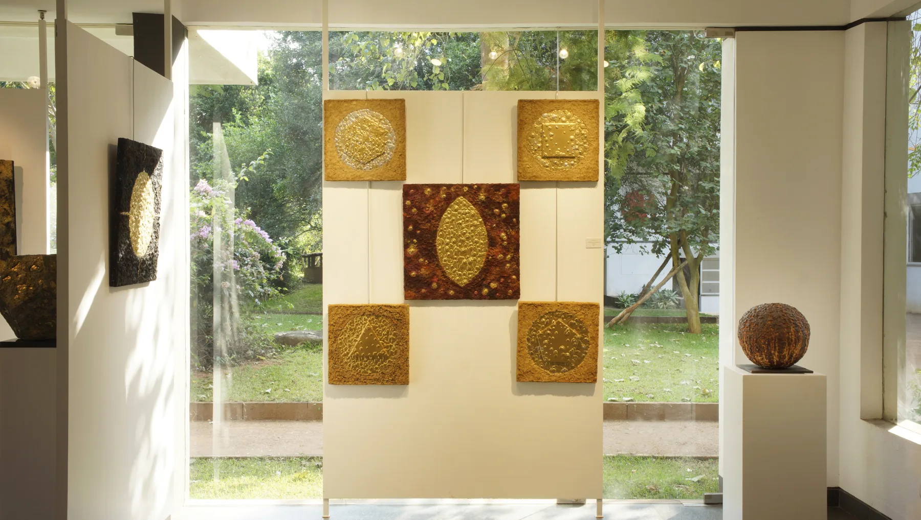 Ceramic sculpture and textured wall works displayed in Jyoti Naoki Eri’s Still Here exhibition