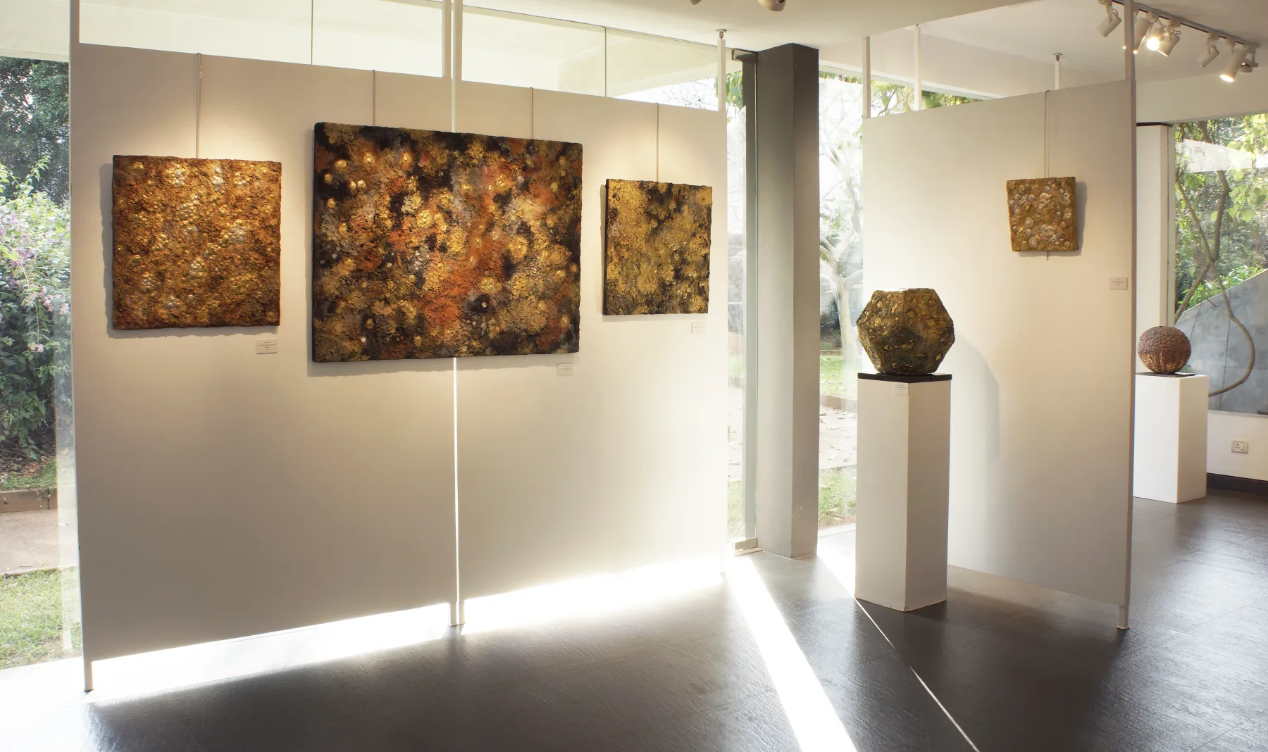 Paintings and sculptural sound works displayed together in the Still Here exhibition