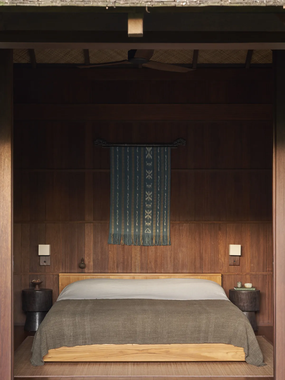 Ikat textile from Bena Village displayed above the built-in bed at Rumah Haruku