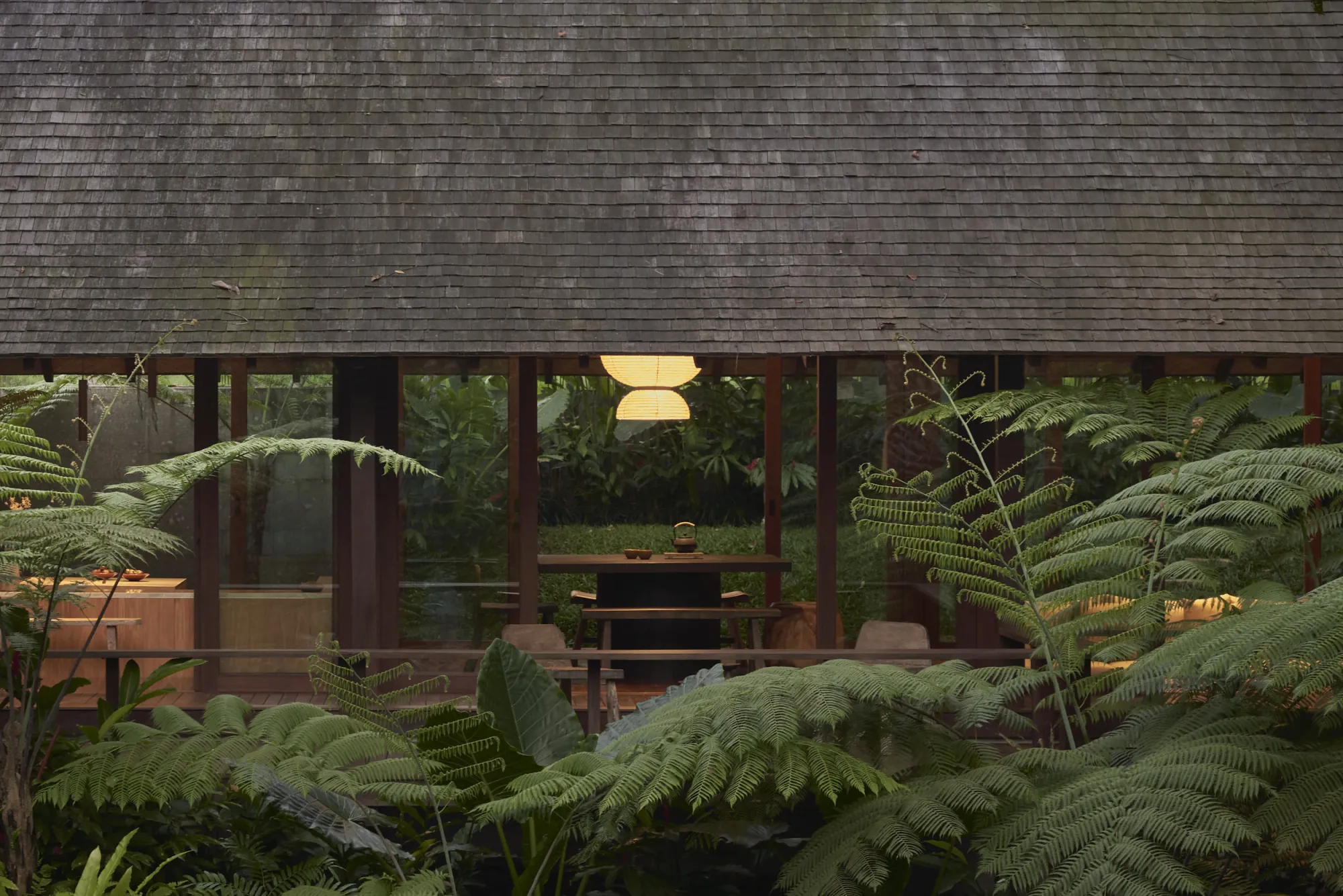 Rumah Haruku by Bada Studio surrounded by mature tropical vegetation in Pejeng, Bali