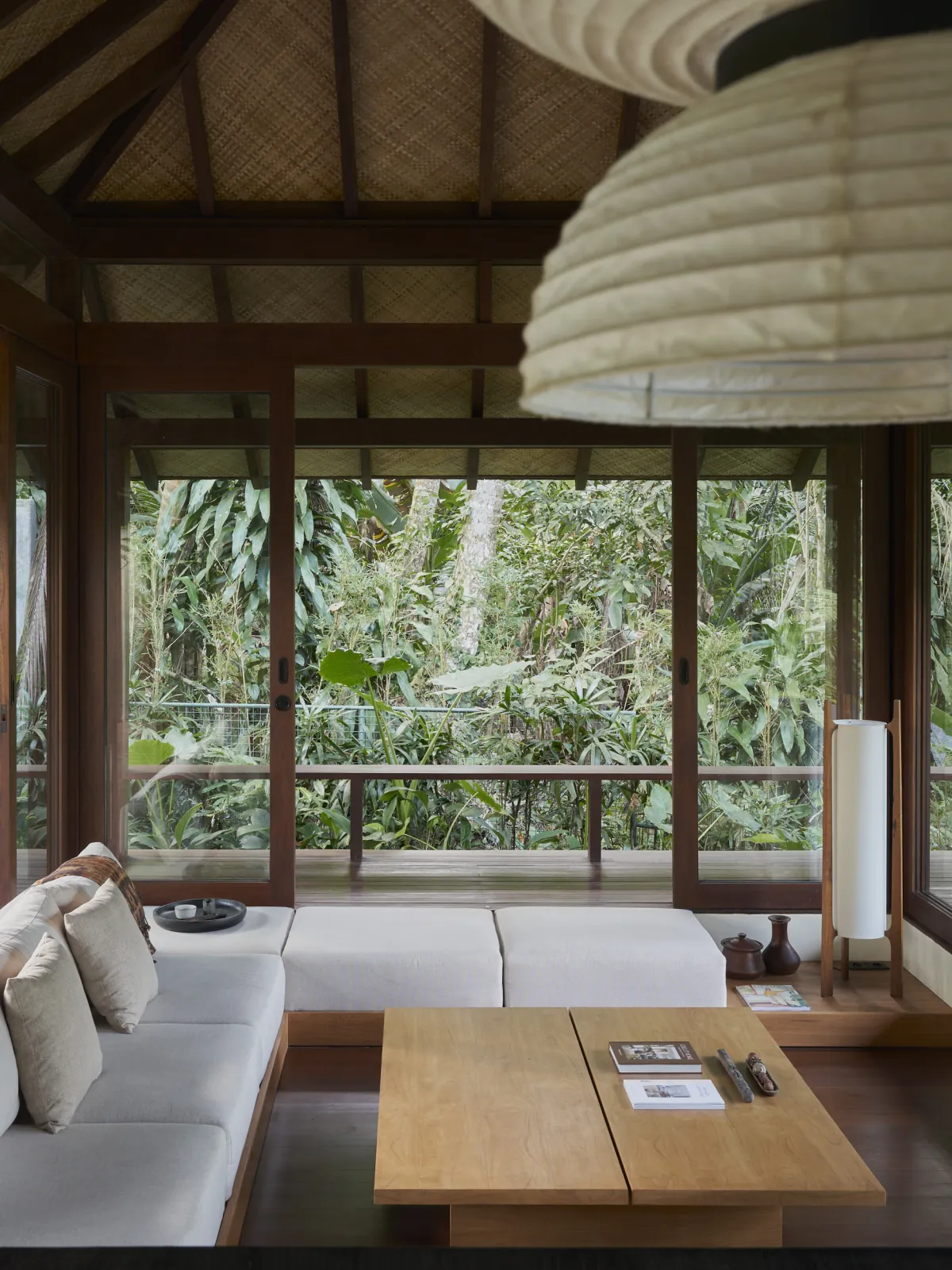 Open timber living room at Rumah Haruku by Bada Studio overlooking the tropical landscape