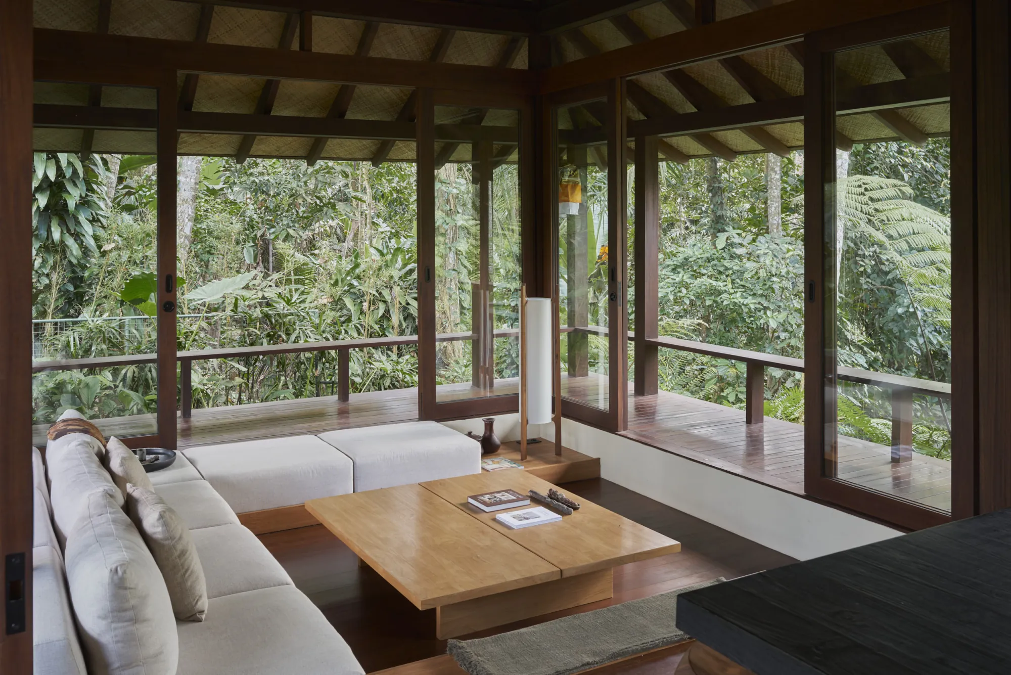 Expandable living room opening onto the landscape at Rumah Haruku by Bada Studio