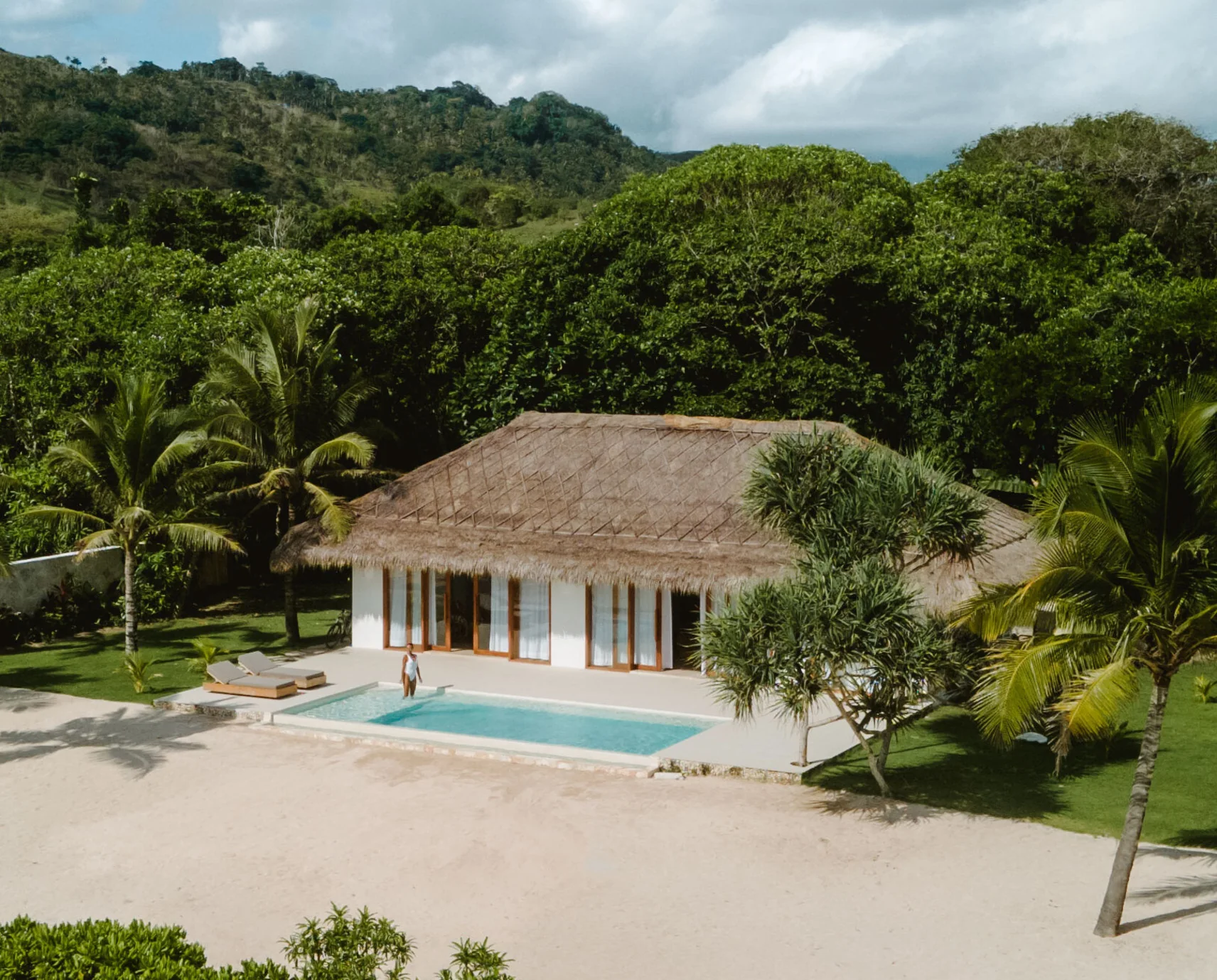 Aerial view of a thatched villa and private pool at The Sanubari in Sumba