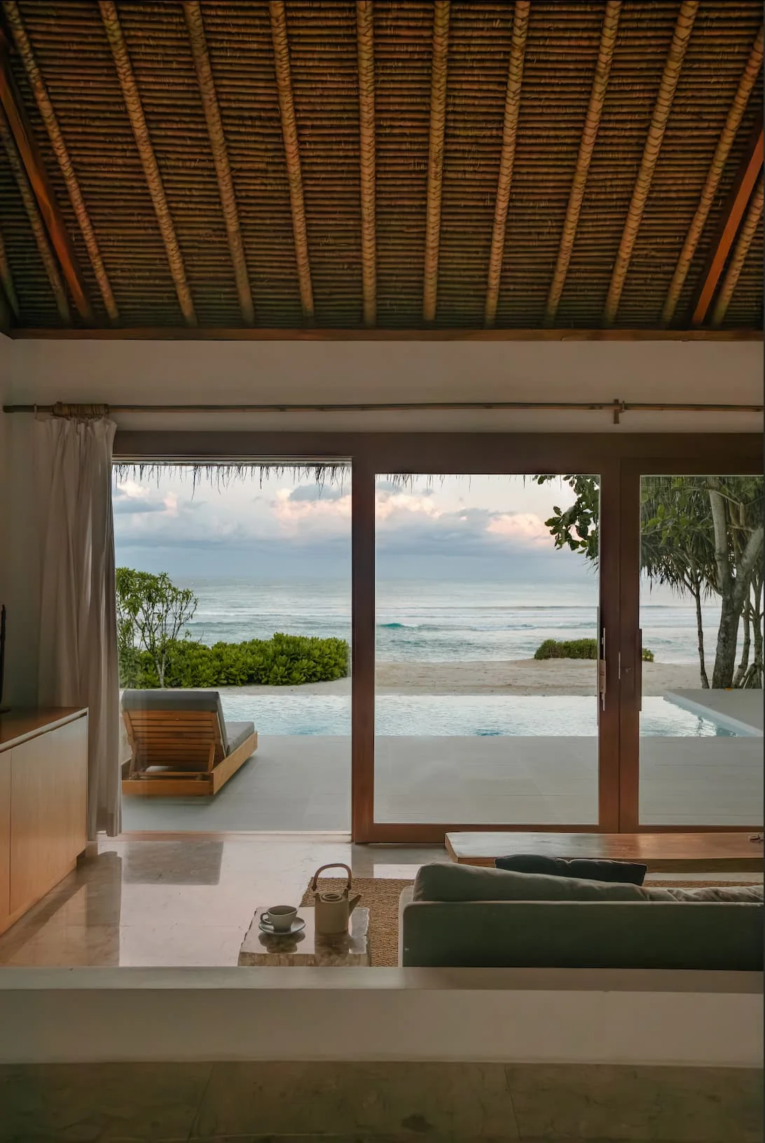 Ocean and private pool seen from the interior of a beachfront studio villa