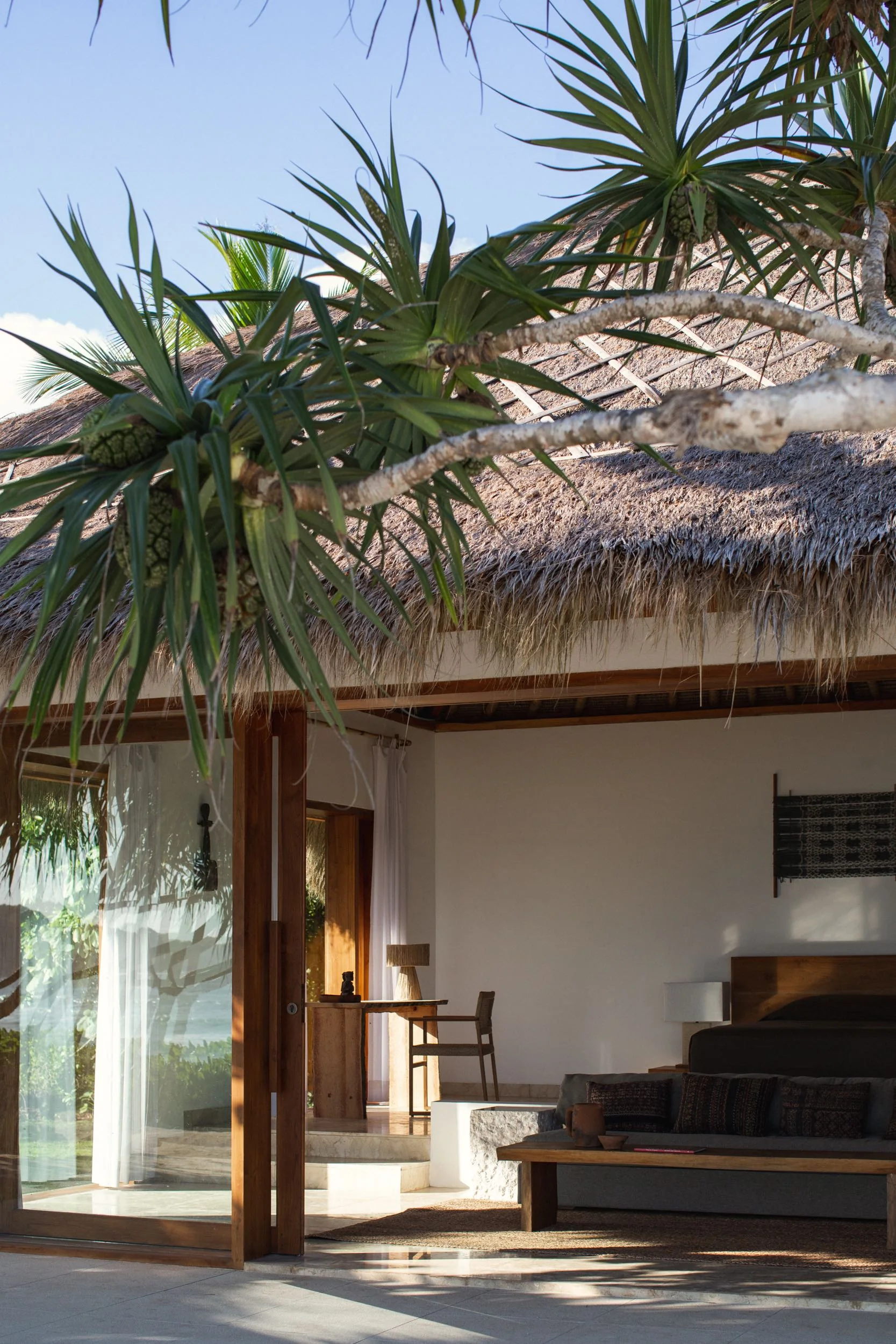 Open beachfront studio villa beneath an alang-alang roof