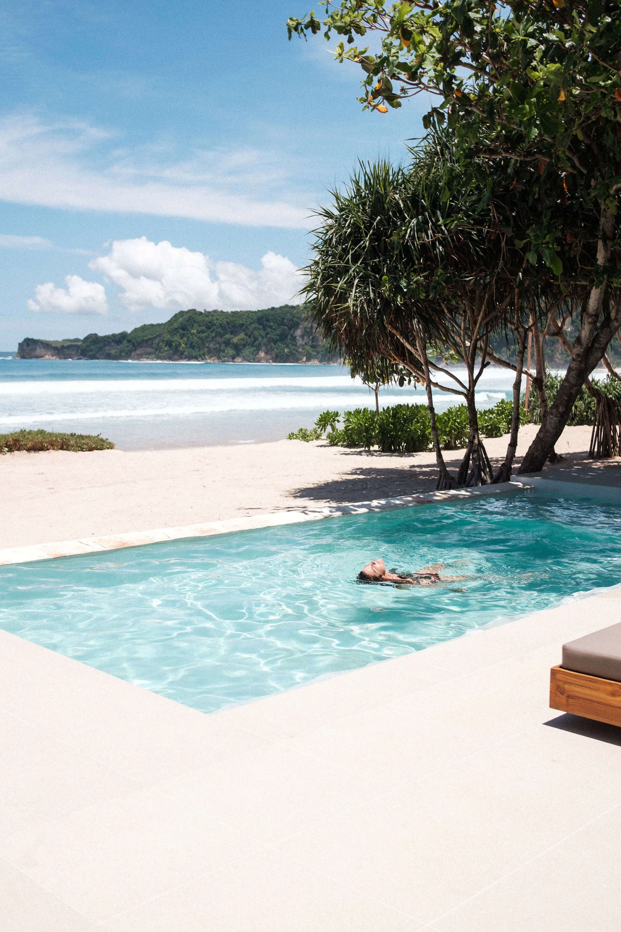 Guest floating in a private pool beside The Sanubari beach