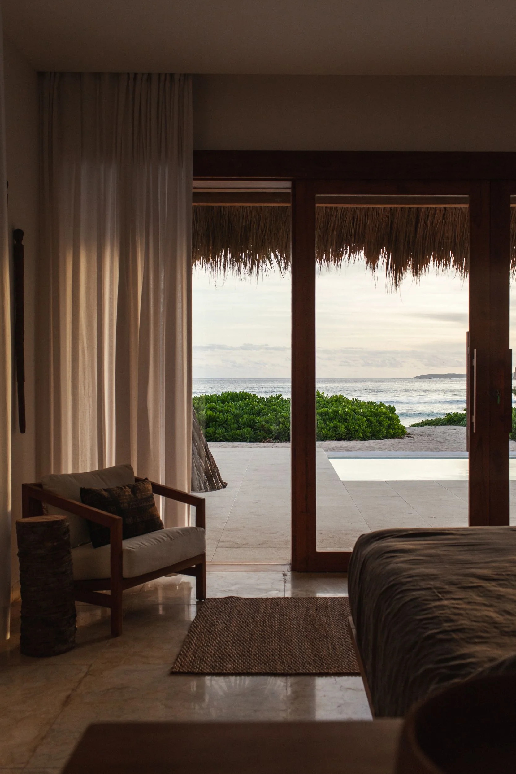 Bedroom opening directly toward a private pool and the ocean