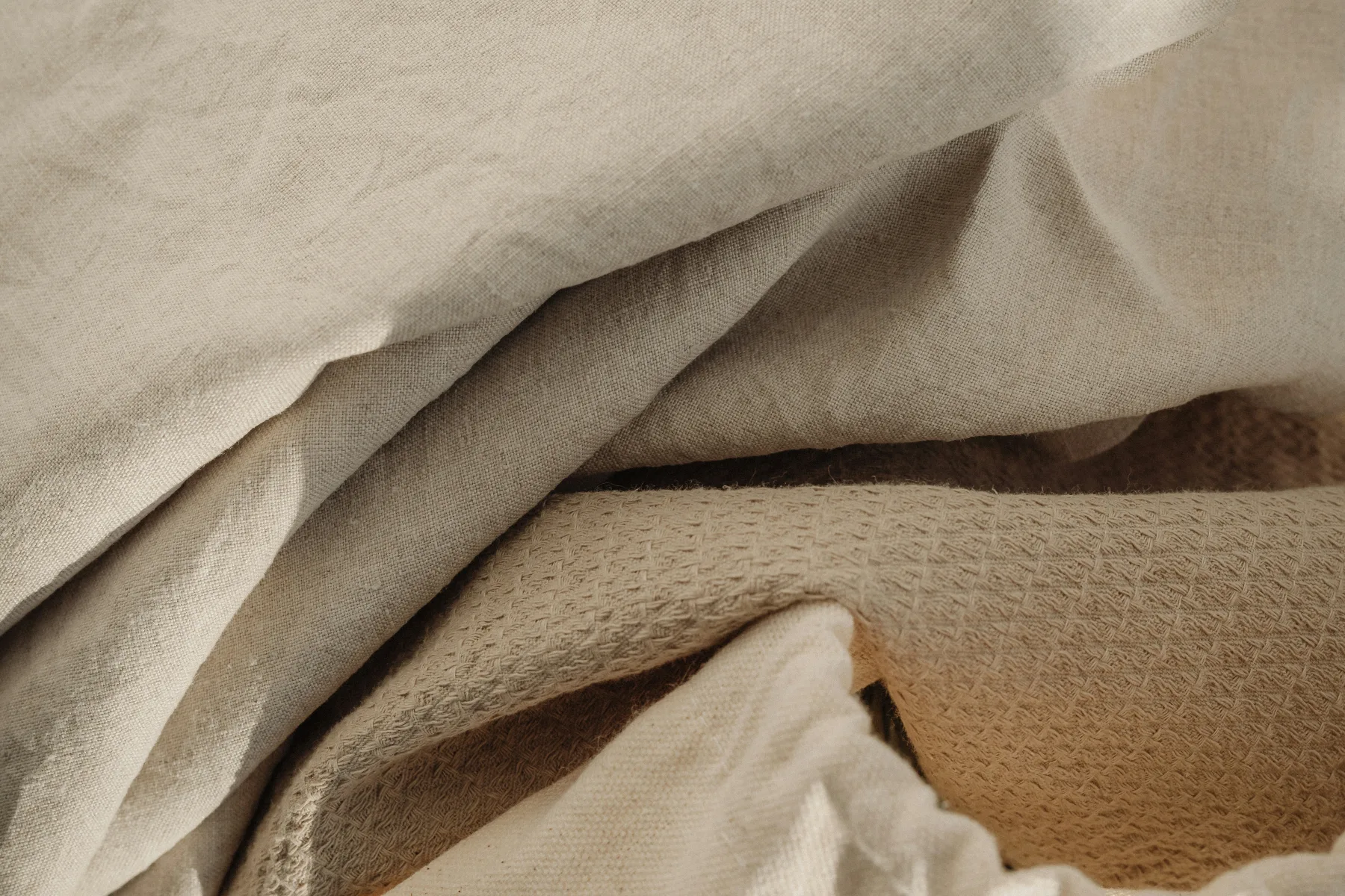 Natural tropical materials and soft neutral textures arranged with restrained warmth