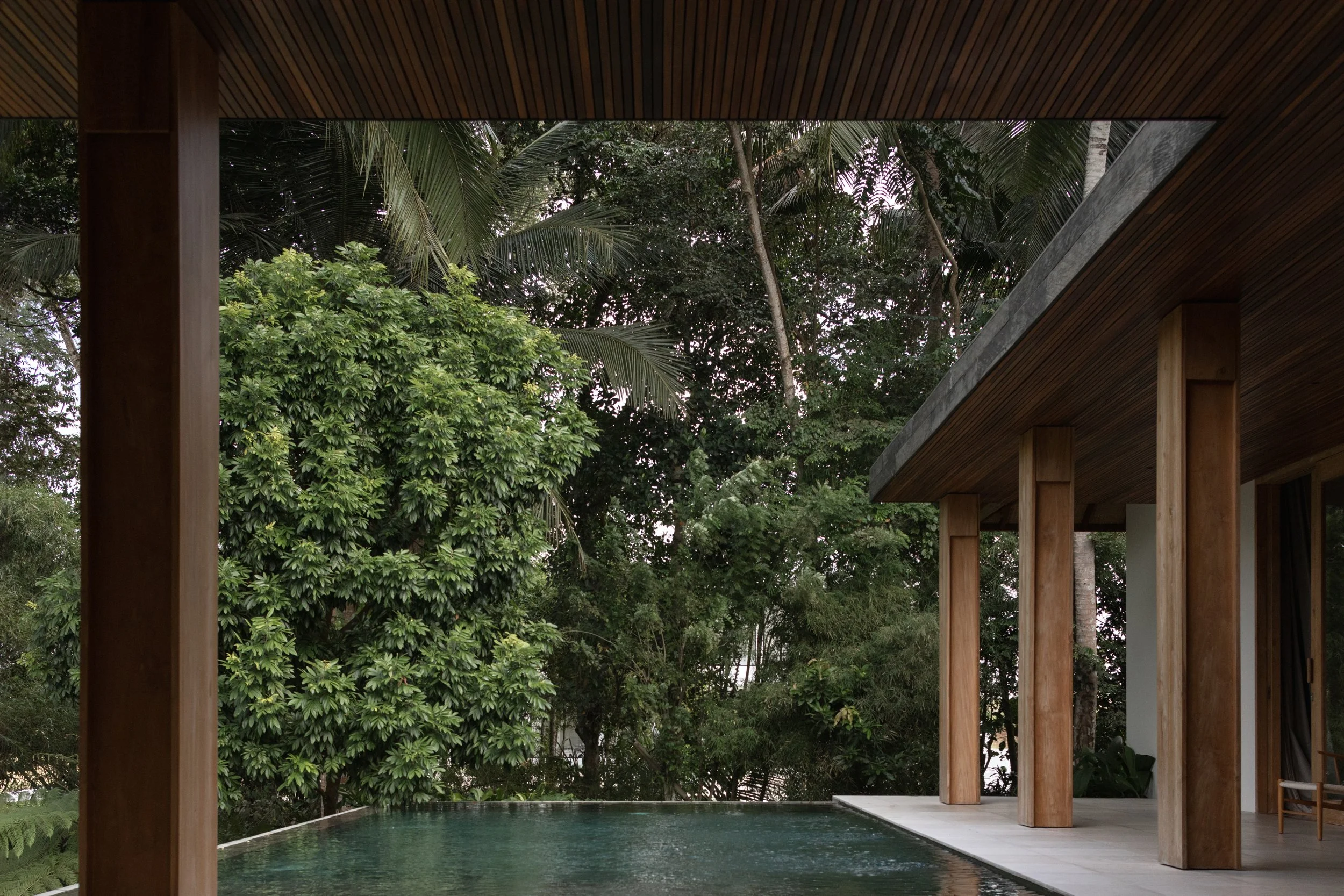 Pejeng House rooflines and terraces surrounded by tropical vegetation