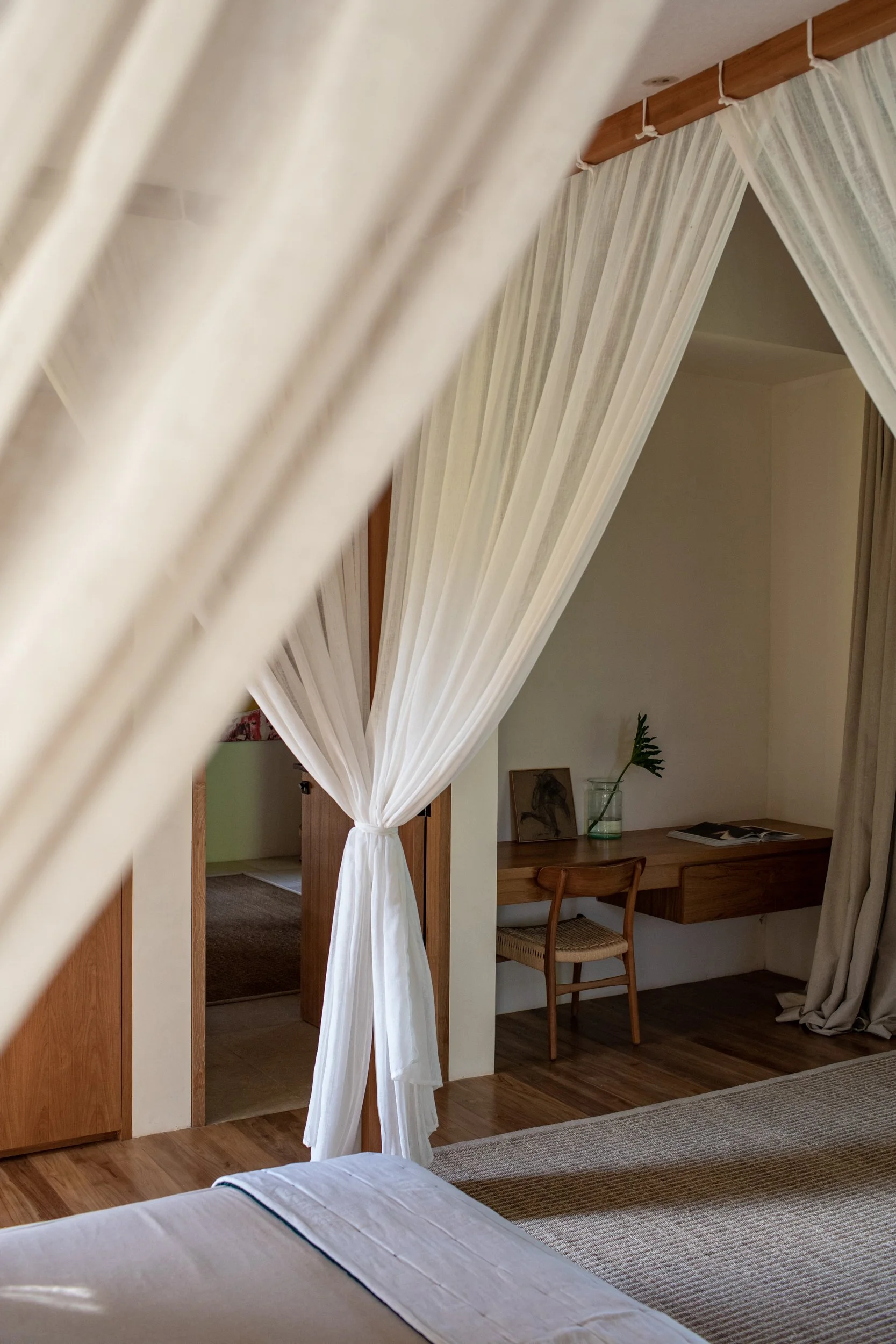 Filtered daylight falling across a warm interior at Pejeng House