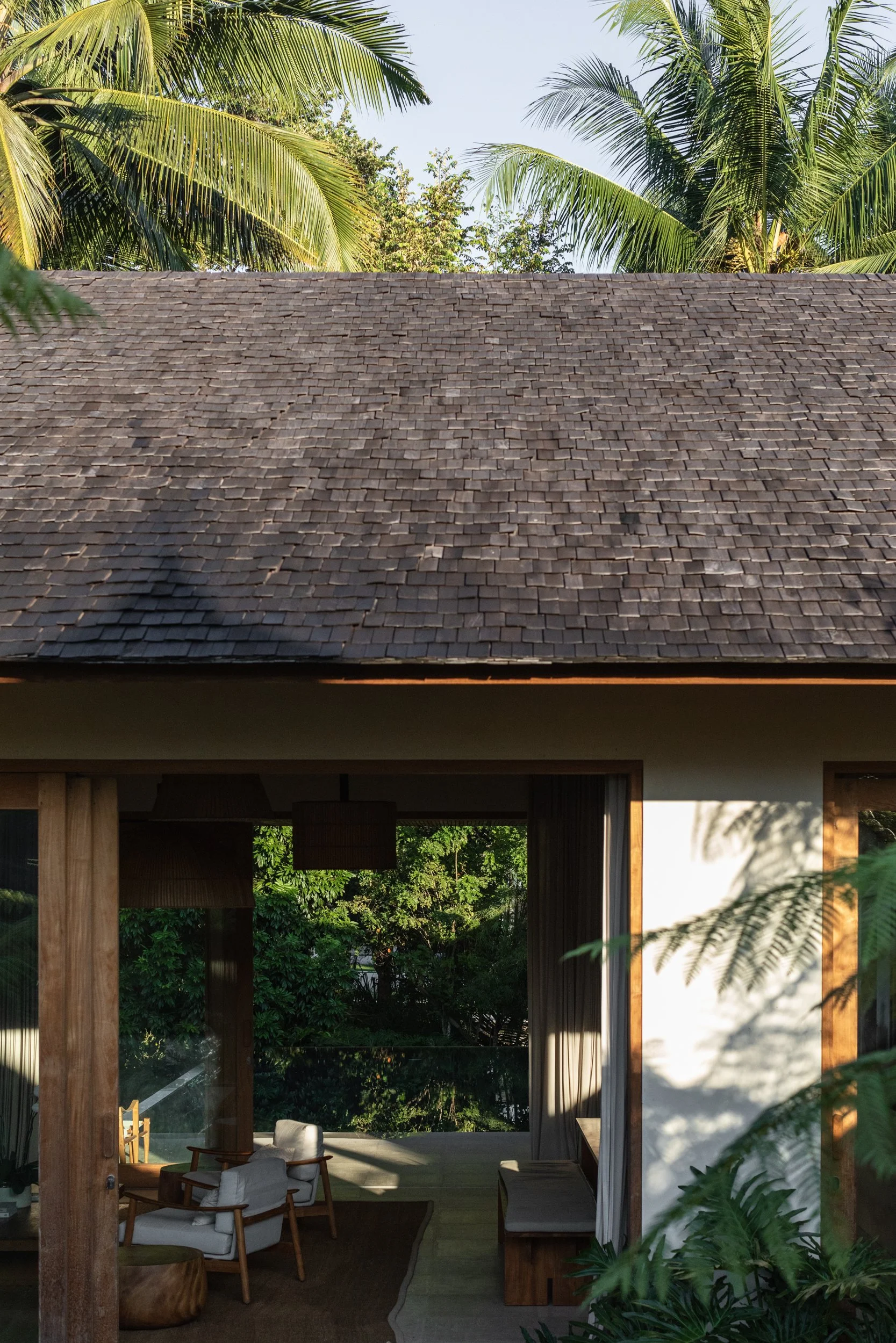 Timber-framed opening connecting Pejeng House to its garden