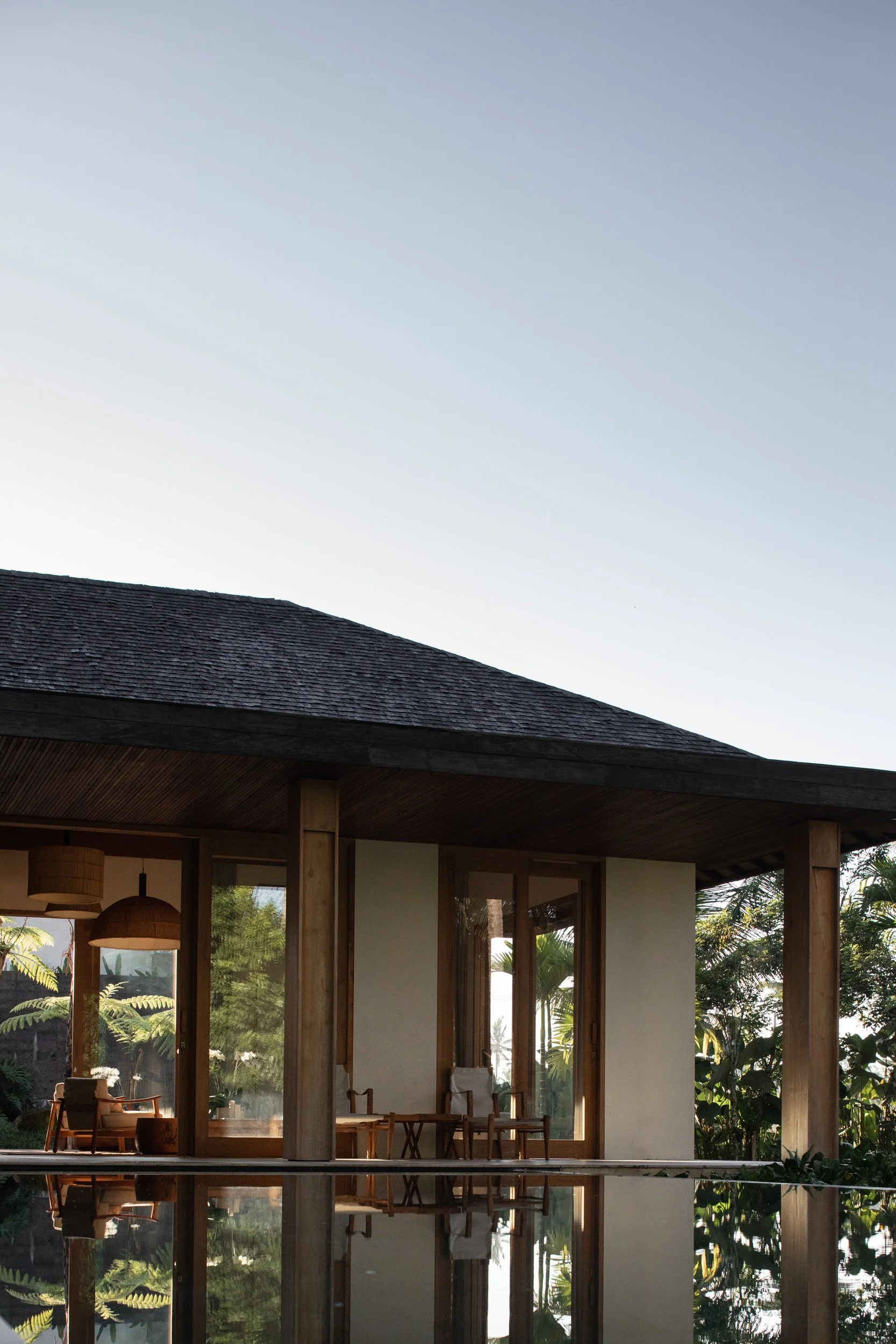 A shaded walkway connecting indoor and outdoor spaces at Pejeng House