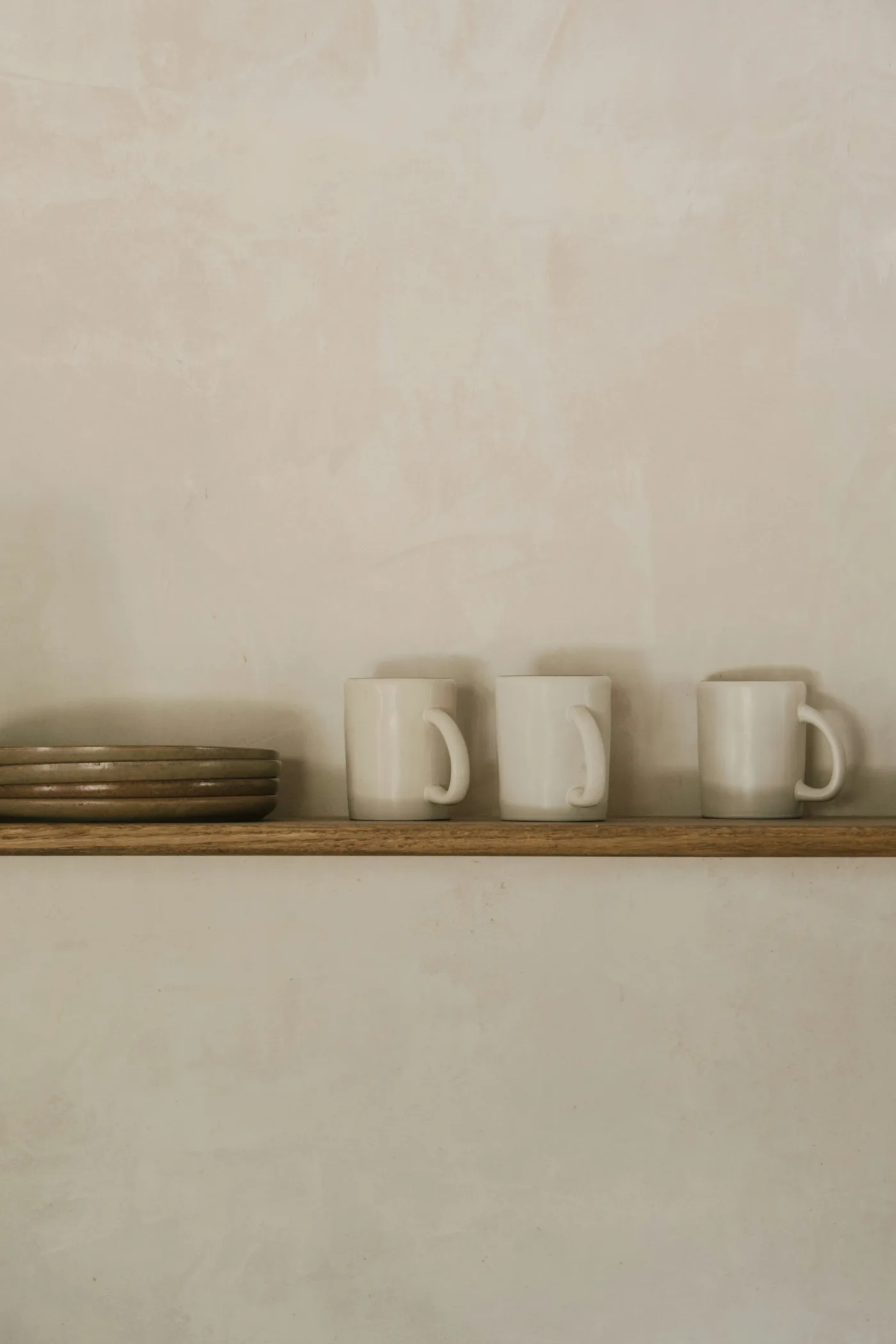 Everyday stoneware and useful objects styled as decor in a tropical minimal kitchen
