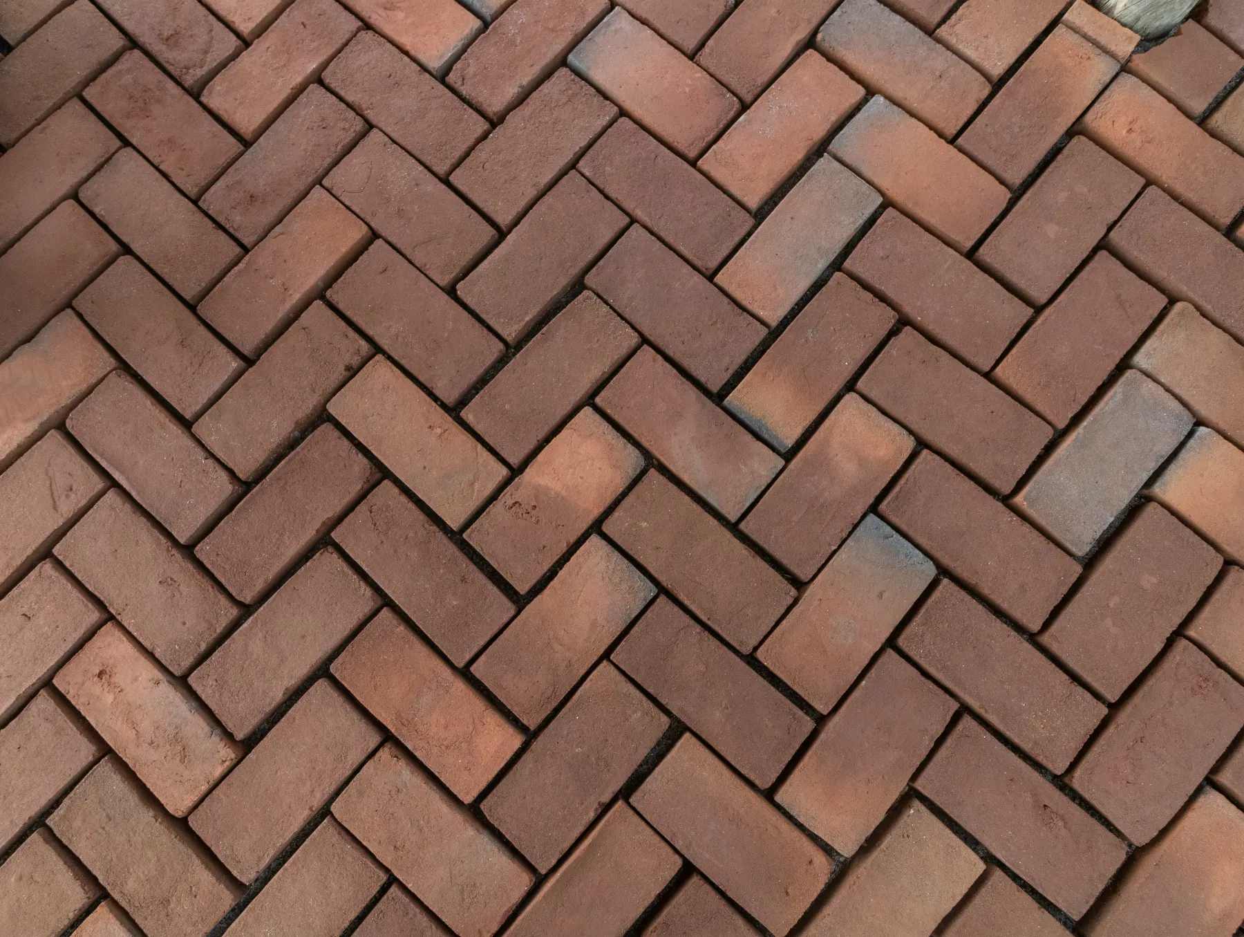 Traditional red clay bricks with natural terracotta, rust, and burnt-sienna colour variation