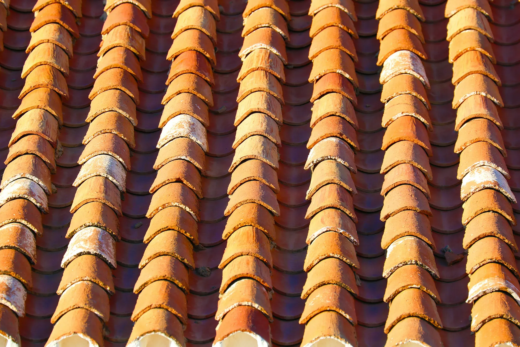 Terracotta roof tiles shaped to create shade, airflow, and heat dissipation in tropical homes
